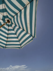 A person relaxing outdoors on a summer afternoon, representing body image and the season.