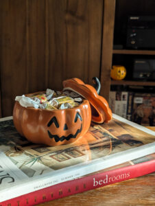 A child's hands sorting wrapped candy on a kitchen table, for a blog on kids and candy