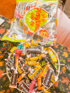 Trick-or-treat bags filled with Halloween candy on a kitchen counter, for a blog on whether parents should limit Halloween candy